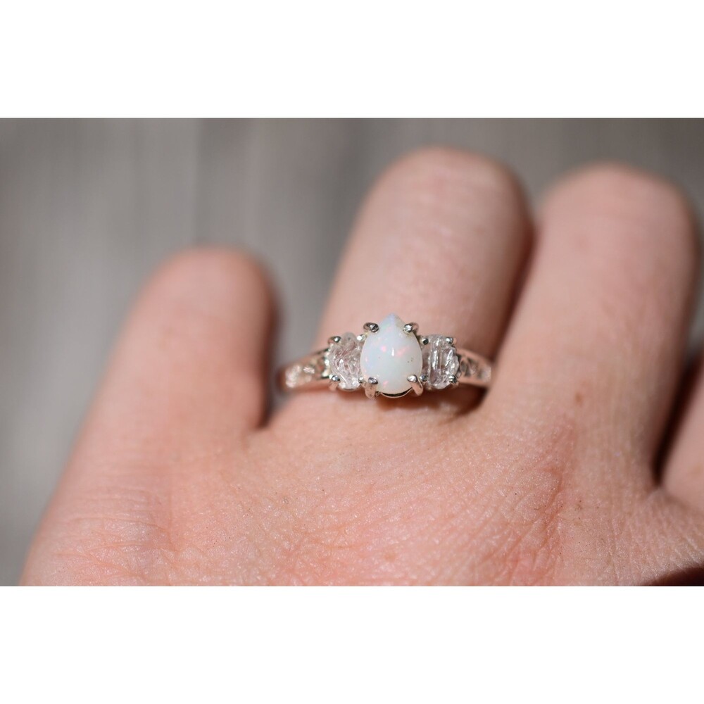 Brilliant opal ring, teardrop or pear shaped center stone with raw clear oval si